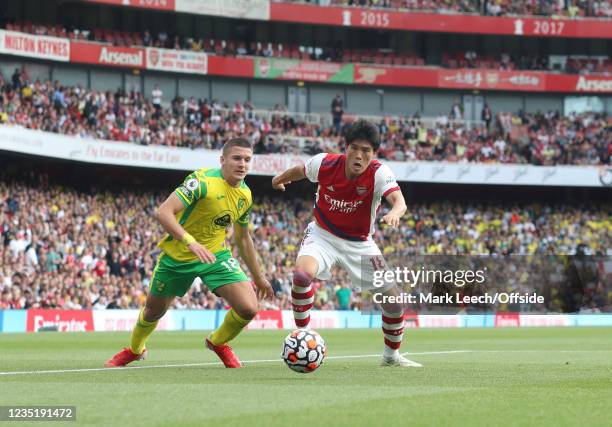 Christos Tzolis of Norwich City and Takehiro Tomiyasu of Arsenal during the Premier League match between Arsenal and Norwich City at Emirates Stadium...