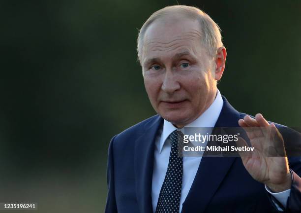 Russian President Vladimir Putin waves during the opening ceremony of the monument to Prince Alexander Nevsky and His Guard at the supposed location...