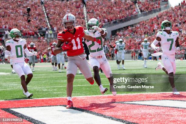 Wide receiver Jaxon Smith-Njigba of the Ohio State Buckeyes runs in a touch down as safety Verone McKinley III Oregon Ducks chases him down in the...