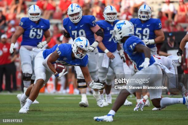 Tight end Tyler Stephens of the Buffalo Bulls reaches for extra yards against the Nebraska Cornhuskers in the second half at Memorial Stadium on...