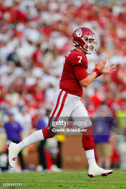 Quarterback Spencer Rattler of the Oklahoma Sooners celebrates a touchdown throw to wide receiver Michael Woods II against the Western Carolina...