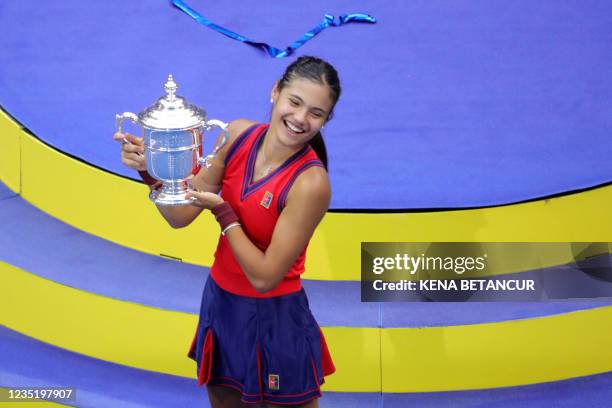 Britain's Emma Raducanu celebrates with the trophy after winning the 2021 US Open Tennis tournament women's final match against Canada's Leylah...