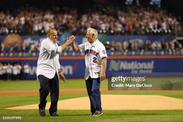 Former Yankees manager Joe Torre and former Mets manager Bobby Valentine, who both managed their teams in 2001, react after the ceremonial first...