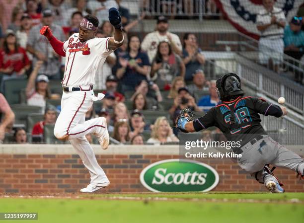 Jorge Soler of the Braves avoids the tag by Marlins catcher Jorge Alfaro to score a run in the 5th inning at Truist Park on September 11, 2021 in...