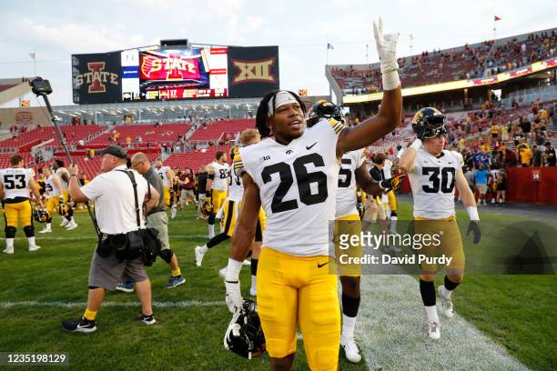 Fefensive back Kaevon Merriweather of the Iowa Hawkeyes, and defensive back Quinn Schulte of the Iowa Hawkeyes wave to fans as the leave the field...