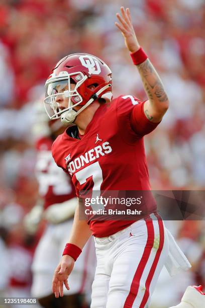 Quarterback Spencer Rattler of the Oklahoma Sooners celebrates with the crowd after throwing a touchdown to running back Eric Gray in the first...