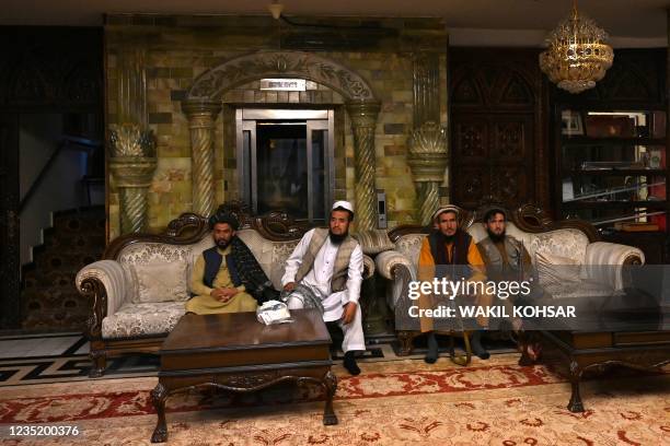 In this picture taken on September 11 Taliban fighters sit inside the home of the Afghan warlord Abdul Rashid Dostum in the Sherpur neighborhood of...