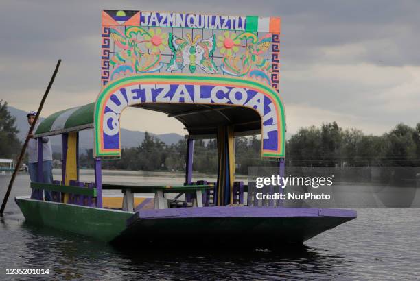 View of a trajinera in the Embarcadero Puente de Urrutía, Xochimilco, during the COVID-19 health emergency and the yellow epidemiological traffic...