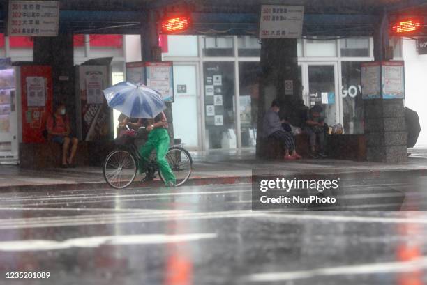 Cyclist seen in strong rains and winds in Keelung, as Typhoon Chanthu bringing torrential rains and damaging winds makes landfall on the island, with...