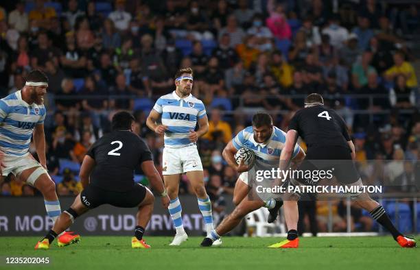 Facundo Gigena of Argentina tries to dodge New Zealand's Brodie Retallick during the Rugby Championship match at Cbus Super Stadium in Gold Coast on...