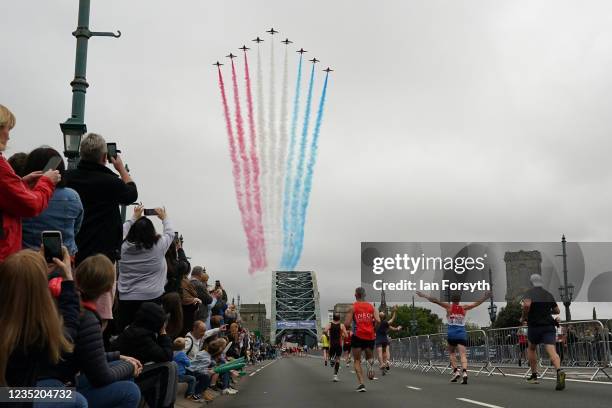 The RAF aerial display team, The Red Arrows make a flypast over the Tyne Bridge during the 40th Great North Run on September 12, 2021 in Newcastle...