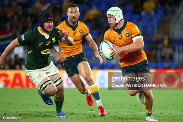 Australia's captain Michael Hooper runs with the ball during the Rugby Championship match against South Africa at Cbus Super Stadium in Gold Coast on...