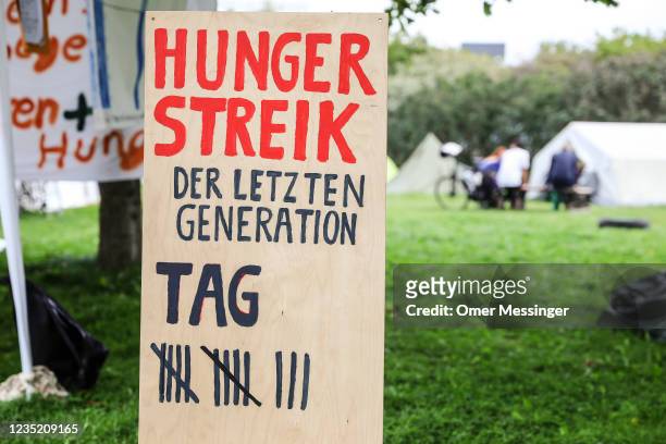 View of a banner marking the 13 day of a hunger strike by climate activists, at a camp near the Reichstag building on September 12, 2021 in Berlin,...