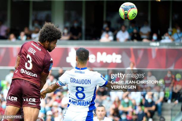 Metz's French defender Matthieu Udol vies with Troyes' French defender Jimmy Giraudon during the French L1 football match between FC Metz and ES...