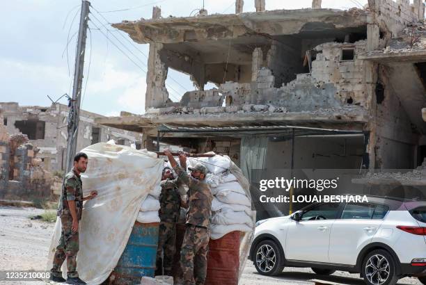 Picture taken during a tour organized by the Syrian Ministry of Information shows Syrian soldiers at a checkpoint in the district of Daraa al-Balad...