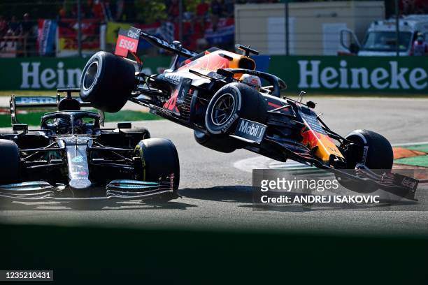 Mercedes' British driver Lewis Hamilton and Red Bull's Dutch driver Max Verstappen collide during the Italian Formula One Grand Prix at the Autodromo...