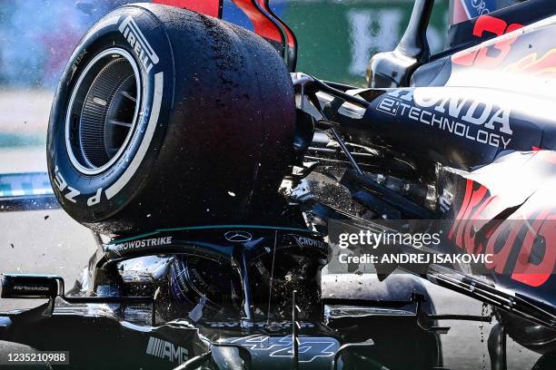 Mercedes' British driver Lewis Hamilton and Red Bull's Dutch driver Max Verstappen collide during the Italian Formula One Grand Prix at the Autodromo...