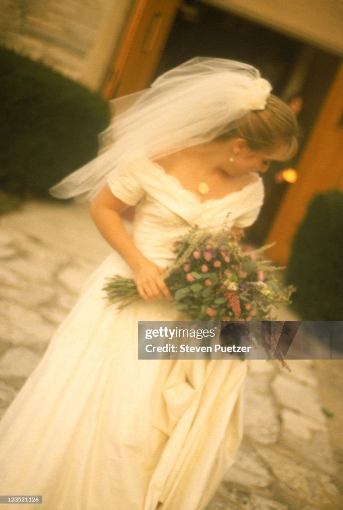 Soft-focus of bride holding bouquet