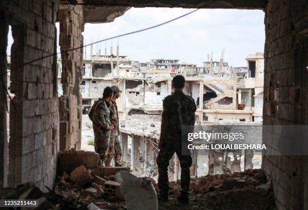 Picture taken during a tour organised by the Syrian Ministry of Information shows Syrian soldiers inside a damaged building in the district of Daraa...