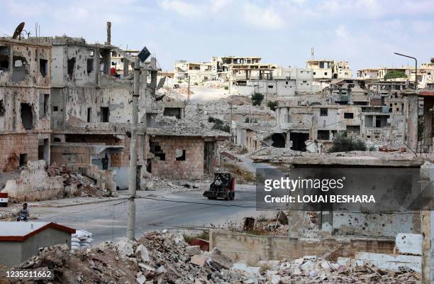 Picture taken during a tour organised by the Syrian Ministry of Information shows a bulldozer in the midst of destruction in the district of Daraa...