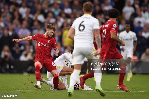 Liverpool's English striker Harvey Elliott gets tackled and suffers a serious leg injury during a tackle by Leeds United's Dutch defender Pascal...