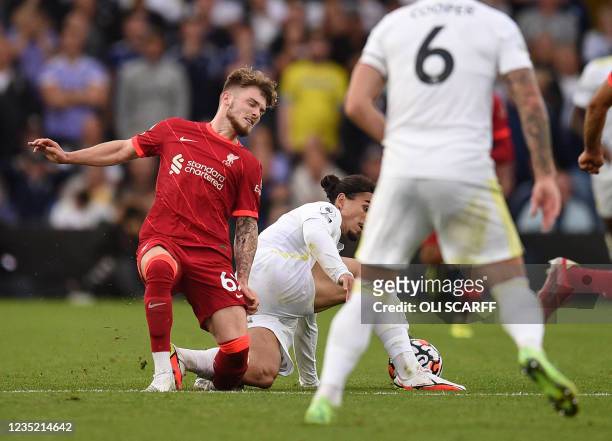 Liverpool's English striker Harvey Elliott suffers a serious leg injury following a tackle by Leeds United's Dutch defender Pascal Struijk during the...