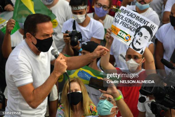 Sao Paulo's governor Joao Doria addresses demonstrators during a protest called by right-wing groups and parties to demand the impeachment of...