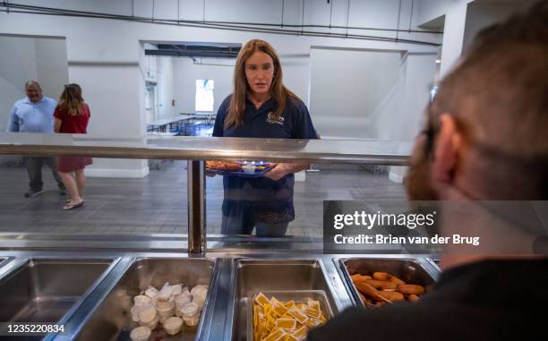 Los Angeles, CA - September 11,2021: Republican gubernatorial candidate Caitlyn Jenner grabs a lunch tray during a tour of the Los Angeles Dream...