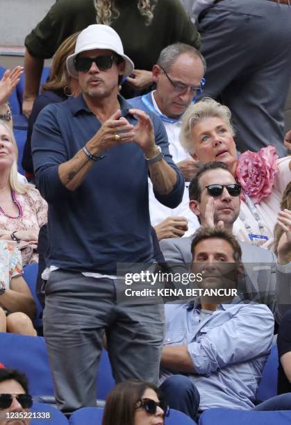 Actors Brad Pitt and Bradley Cooper watch the match between Serbia's Novak Djokovic and Russia's Daniil Medvedev during their 2021 US Open Tennis...