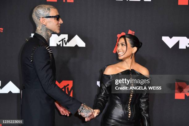 Drummer Travis Barker and US personality Kourtney Kardashian arrive for the 2021 MTV Video Music Awards at Barclays Center in Brooklyn, New York,...