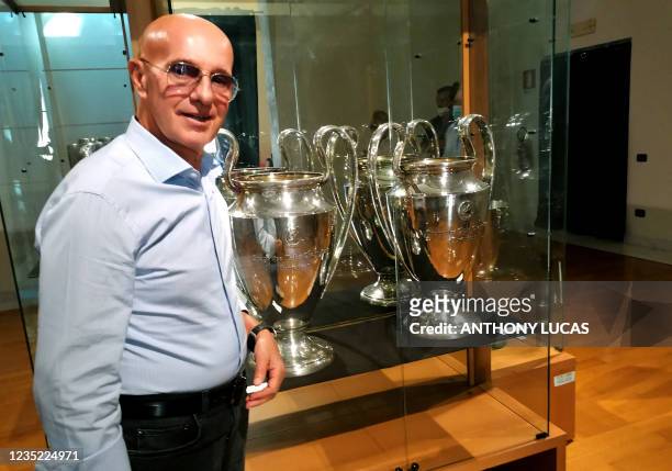 Former head coach of the Italian national football team and twice manager of AC Milan, Arrigo Sacchi poses in front of reproductions of the then...