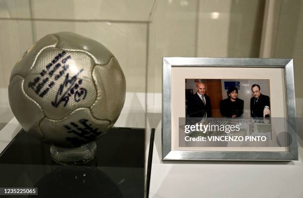 Ball signed by football myths Alfredo Di Stefano, Diego Maradona and Pele is displayed at the exhibition "Oltre il Sogno, L'emozione del calcio...