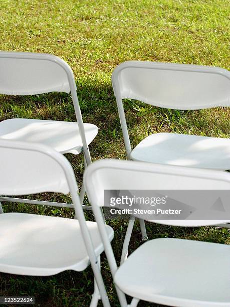 white steel chairs - folding chair stock-fotos und bilder