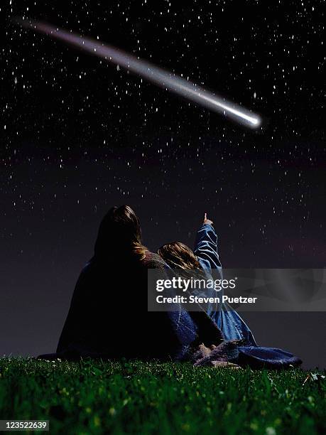 mother and daughter looking at a comet - comet stock pictures, royalty-free photos & images