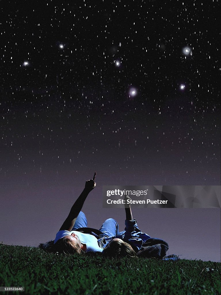 Mother and daughter looking at stars