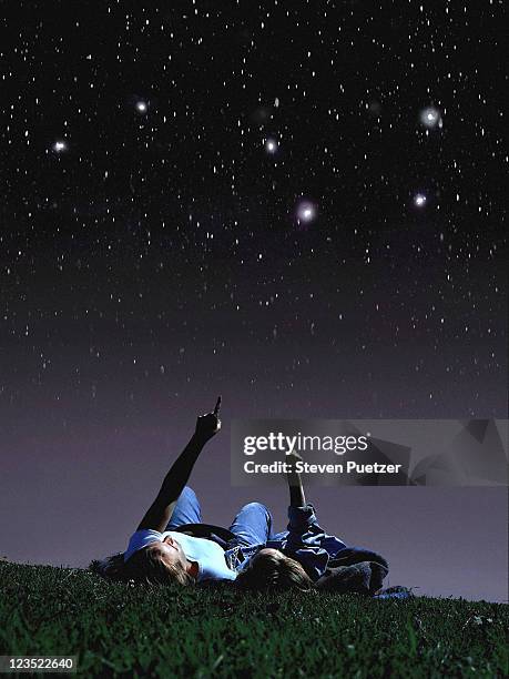 mother and daughter looking at stars - kids astronomy stock pictures, royalty-free photos & images