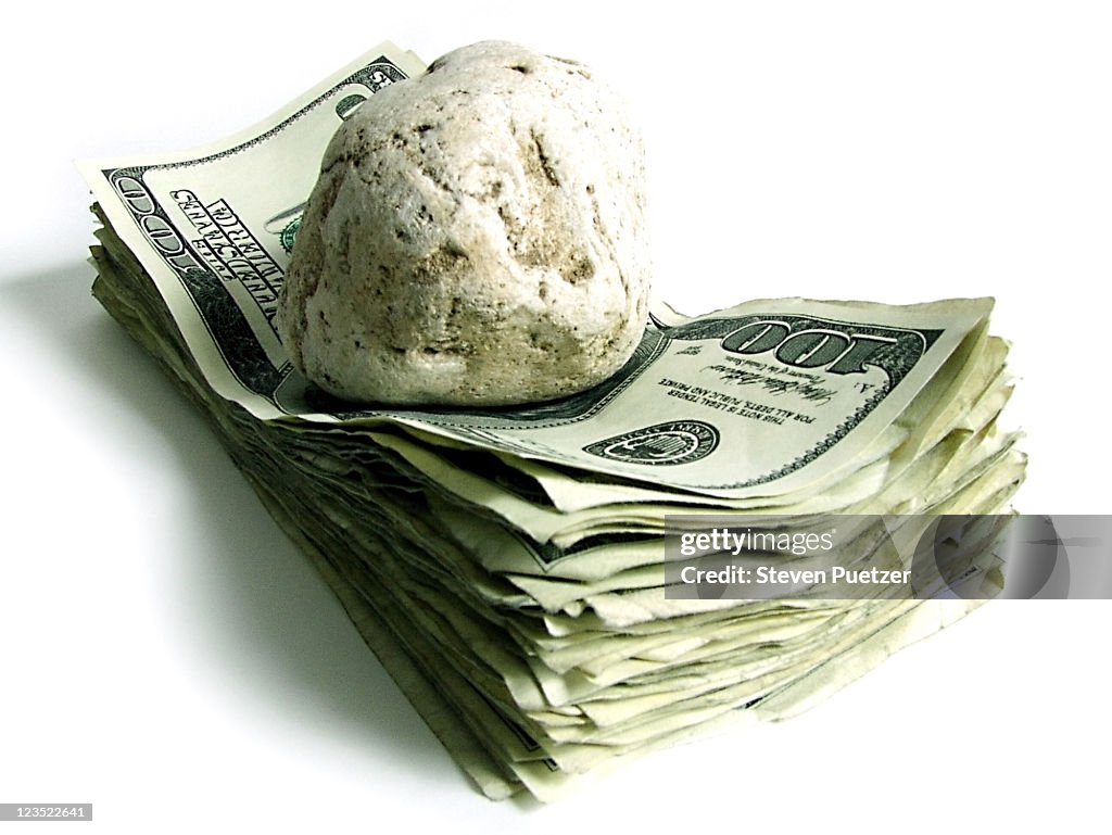 Money held down by a rock