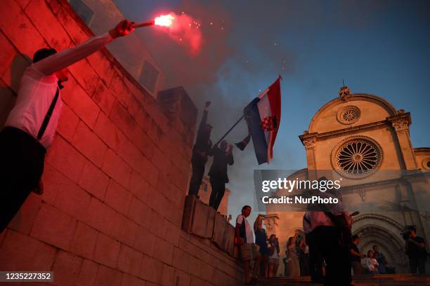 People with flares celebrate a wedding in front of the Cathedral of St James in Sibenik, Croatia on September 11, 2021.