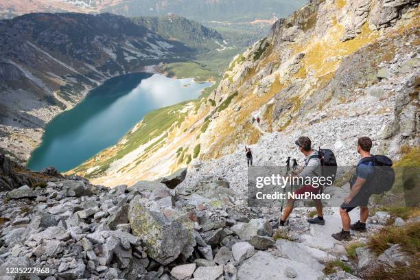 Tourists walk a mountain trail in the area of Black Lake and Granat summits in Tatra mountains, Poland as warm weekend attracted crowds on this...