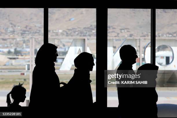 People leave to board on a Pakistan International Airlines plane, which is the first international commercial flight to land since the Taliban retook...