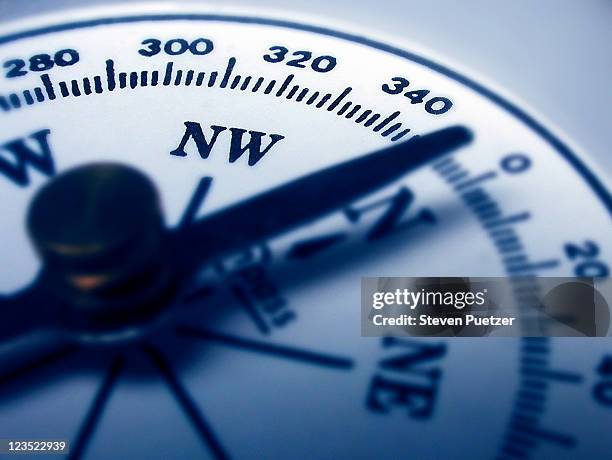 compass pointing north - navigational compass stockfoto's en -beelden