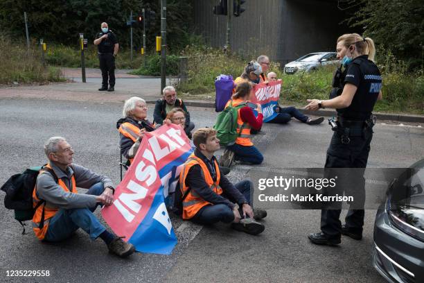 Police officer asks Insulate Britain climate activists to move out of a slip road from the M25 which they had blocked, causing a long tailback on the...