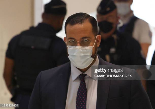 Alexandre Benalla , wearing a mask, a former bodyguard to French President, arrives for trial in Paris on September 13 for an alleged assault during...