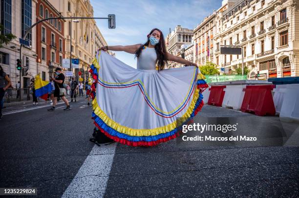 Protester wearing a dress with the colors of the Colombian flag during a demonstration against the visit to Madrid Book Fair 2021 of Colombian...