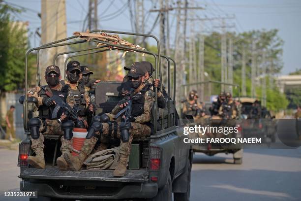 Pakistan's army commandos depart in their vehicles after escorting a convoy of vans carrying New Zealand's and Pakistani players to attend practice...