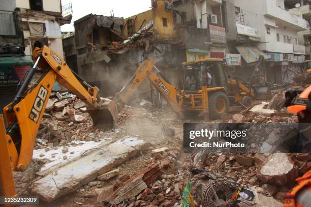 Rescue workers remove debris to search for survivors after a four-storey building collapsed near Subzi Mandi area, in New Delhi, India on September...