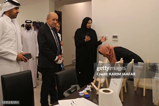 French Foreign Minister Jean-Yves Le Drian , accompanied by Qatars assistant Foreign Minister Lolwah al-Khater , visits refugees from Afghanistan at...