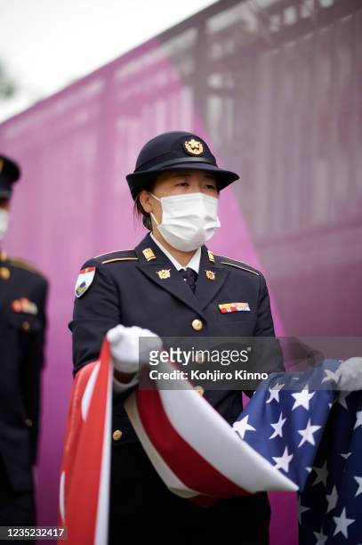 Summer Olympics: View of soldier wearing mask and holding USA flag for medal ceremony during Women's Final Round at Kasumigaseki CC. Tokyo, Japan...