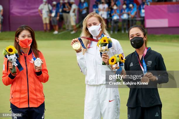 Summer Olympics: USA Nelly Korda holding up gold medal, Japan Mone Inami holding up silver and New Zealand Lydia Ko holding up bronze after Women's...