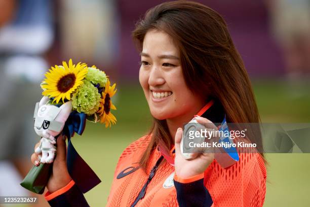 Summer Olympics: Closeup of Japan Mone Inami victorious, holding up silver medal after Women's Final Round at Kasumigaseki CC. Tokyo, Japan 8/7/2021...